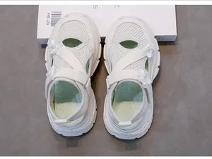 White mesh girls' sandals featuring pearl flower decorations and soft sporty soles.