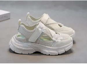 Detail shot of off-white girls' mesh sandals with floral pearl accents and soft thick soles.
