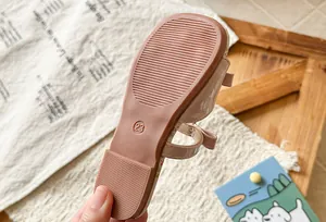 Close-up of non-slip sole texture on girls' bow princess sandals
