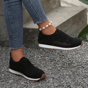 Close-up of black breathable mesh sneakers for women in a casual outdoor setting
