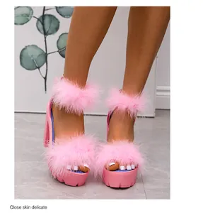 Close-up of pink platform sandals featuring fluffy fur straps and thick block heels.