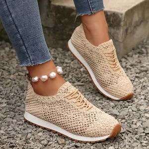 Detailed macro view of beige breathable mesh crochet sneakers with elegant lace-up design