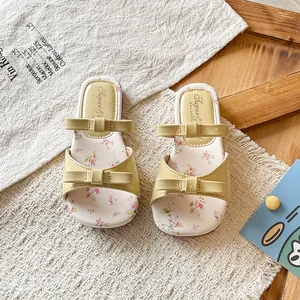 Elegant yellow girl's sandals with double bows and vintage floral print insole.