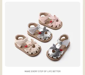 Toddler girls' soft-sole bow sandals in pink, silver, and beige with cherry detail.