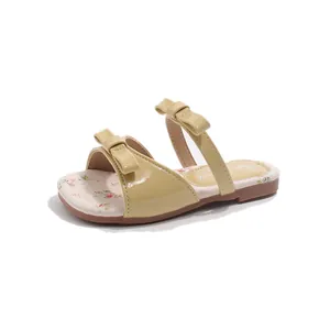 Elegant beige girls' princess sandals featuring double bow knots and a charming floral insole