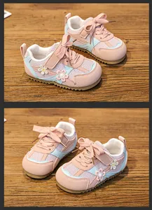 Close-up detail of pink mesh toddler girl sneakers featuring decorative flower accents