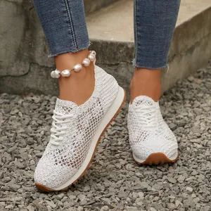 Detailed close-up view of white breathable mesh sneakers featuring a comfortable lace-up design