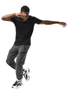 Detailed view of a men's basic black cotton t-shirt paired with grey fleece cargo pants