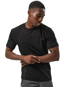 A high-quality detail view of a plain black cotton t-shirt worn by a male model