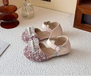 Close-up detail of pink sparkly girls princess shoes with crystal flower decorations