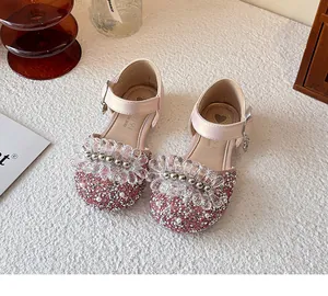 Detail view of pink girl's princess shoes with sparkly crystals and sequin details