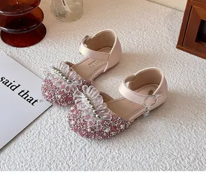 Detail view of pink glitter girl's princess shoes with crystal floral bead decoration