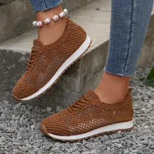 Detailed view of women's brown floral mesh sneakers with breathable crochet texture