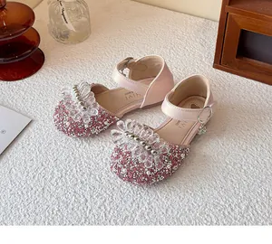 Detailed view of pink girls' princess shoes featuring sequins and crystal flower accents
