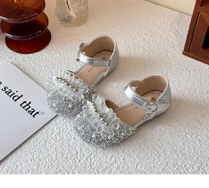 Glittery silver children's Mary Jane shoes with crystal flower and pearl accents.