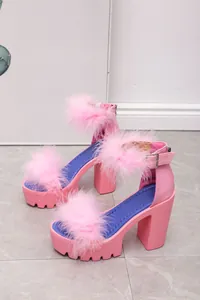 Detailed view of pink platform sandals with fluffy faux fur and stable chunky heels