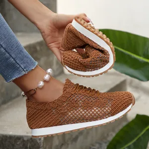 Close-up of flexible brown mesh sneakers showing softness and breathable lace texture