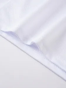 Close-up detail of breathable white mesh fabric and hem stitching on men's vest