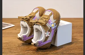 Close-up of girls breathable mesh sneakers with purple accents and floral design