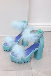 Close-up of light blue platform sandals with faux fur trim and chunky high heels