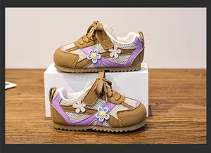 Detail of girl's toddler shoes featuring breathable mesh fabric and flower decorations