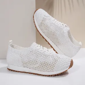 Detailed view of white breathable mesh lace-up sneakers for women with floral pattern