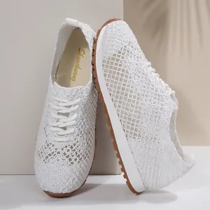 Detailed view of women's white breathable mesh sneakers featuring intricate lace texture