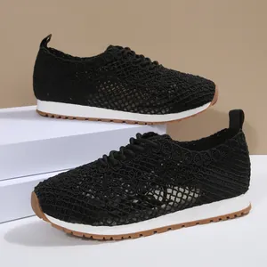 Detail of breathable black mesh upper and white sole on women's casual sneakers