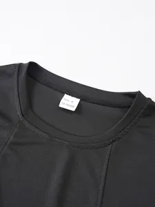 Close-up detail of round neck collar and size label on black breathable mesh tank top