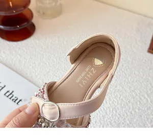 Close-up of pink crystal princess shoe with heart-patterned insole and silver buckle
