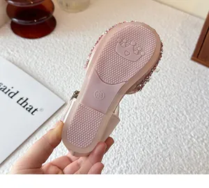 Detailed macro view of pink girl's princess sandal anti-slip sole with crown design