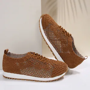Detailed view of the breathable brown mesh sneakers with delicate crochet floral pattern.