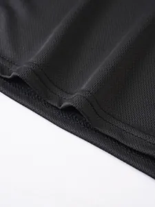 Detailed macro shot of breathable black mesh fabric and sturdy hem stitching.