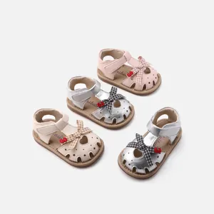 Cute baby girl toddler sandals with bow and strawberry charm details in multiple colors.