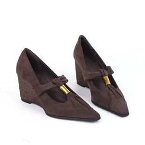 Detail view of vintage brown suede Mary Jane shoes with pointed toe and wedge heel.