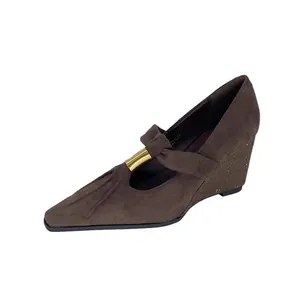 Detailed side view of retro brown suede pointed-toe Mary Jane style wedge shoes