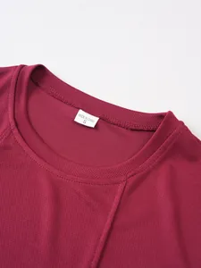 Close-up view of men's breathable burgundy mesh tank top neckline with size tag