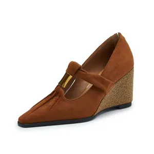 Close-up of brown suede pointed Mary Jane wedge with gold buckle and beaded heel