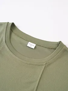 Close-up of olive green breathable mesh tank top neckline with size label