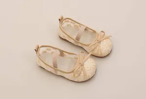 Detailed view of breathable mesh girl's princess shoes with floral embroidery and bows