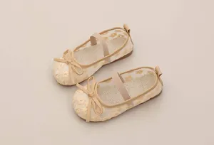 Detail of breathable beige mesh girls' Mary Jane shoes with floral embroidery and bow