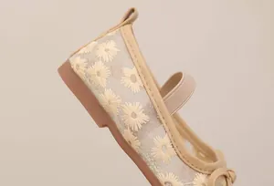 Detail showing embroidered daisy pattern on breathable mesh girl's princess shoe