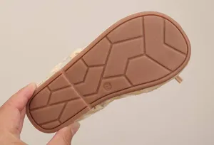 Detailed view of non-slip rubber sole with geometric patterns for girls' dance shoes.