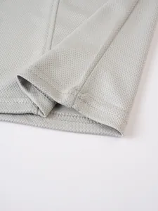 Close-up of breathable grey mesh fabric and durable stitching on men's athletic vest hem