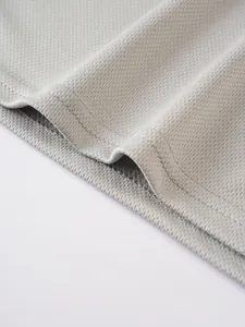 Close-up of breathable grey mesh fabric and reinforced hem stitching on men's tank top.