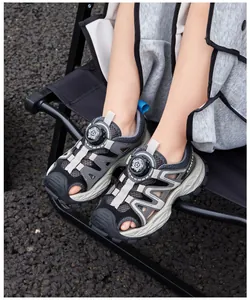 Breathable boy's athletic sandals featuring a rotary buckle and protective closed-toe design