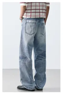 Back view of light wash wide-leg jeans with distressed knee detail and cleanfit style