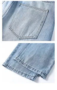 Close-up of the back pocket and hem stitching on light blue straight denim jeans
