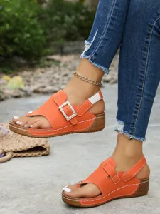 Stylish orange wedge sandals with rhinestone square buckle and comfortable thong design.