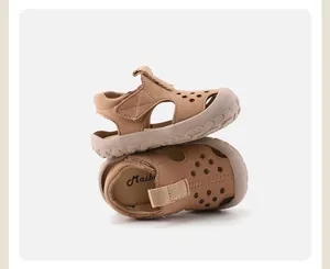 Side view of tan toddler sandals with breathable hollow-out design and soft sole.